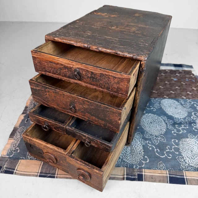 This small Japanese drawer chest is a rare, characterful example of a traditional calligraphy or writing cabinet, in Japan...