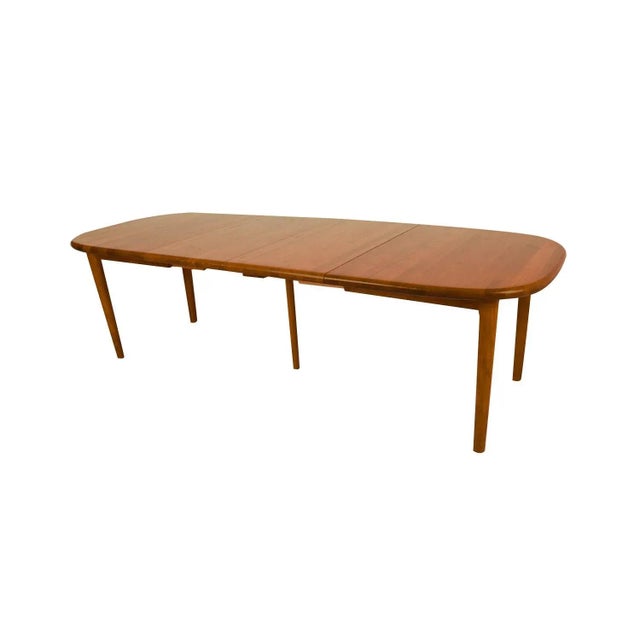 Beautiful Mid-Century Modern teak rounded corners rectangle expandable dining table, circa 1970’s. Featuring richly...