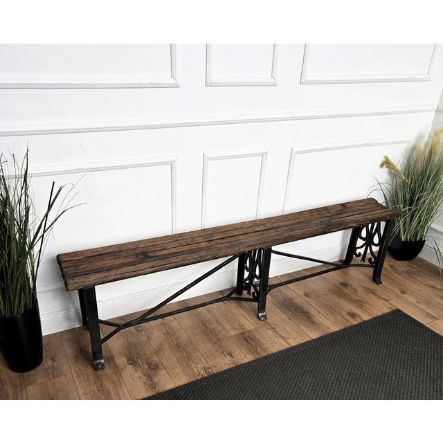 Beautiful Italian country wooden bench with metal bottom and slat wooden top seating in original aged natural color giving...