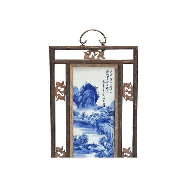 This vintage Chinese wall art panel features a hand-painted blue and white porcelain plaque set within an intricately...