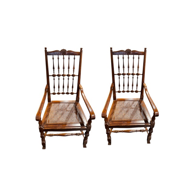 Set of 10 vintage Henredon dining chairs featuring beautifully carved spindle backs, warm wood tones, and classic cane...