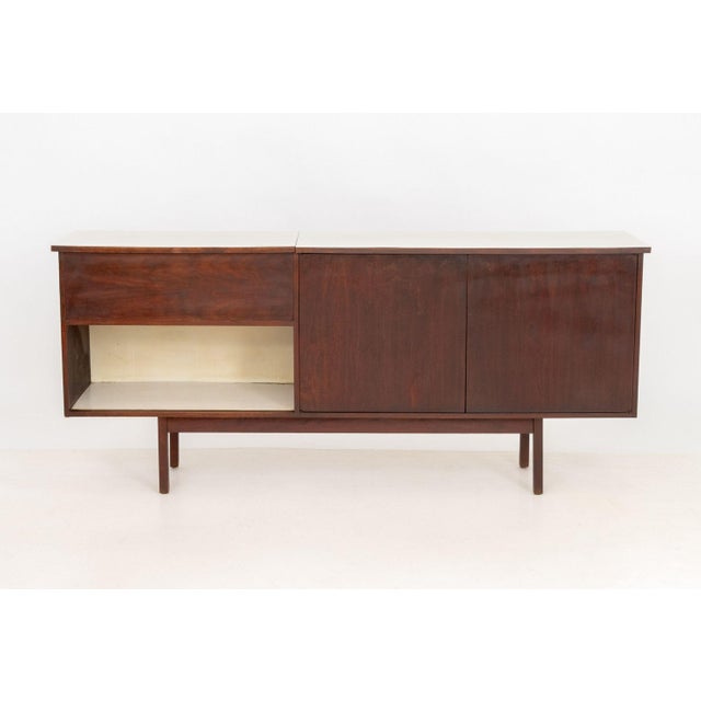 Scandinavian Modern Style Rosewood Sideboard, with white laminate top above two door cabinet with two shelves on the...