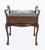 An elegant Edwardian mahogany piano stool of attractive design and fine craftsmanship. The stool is raised on graceful...