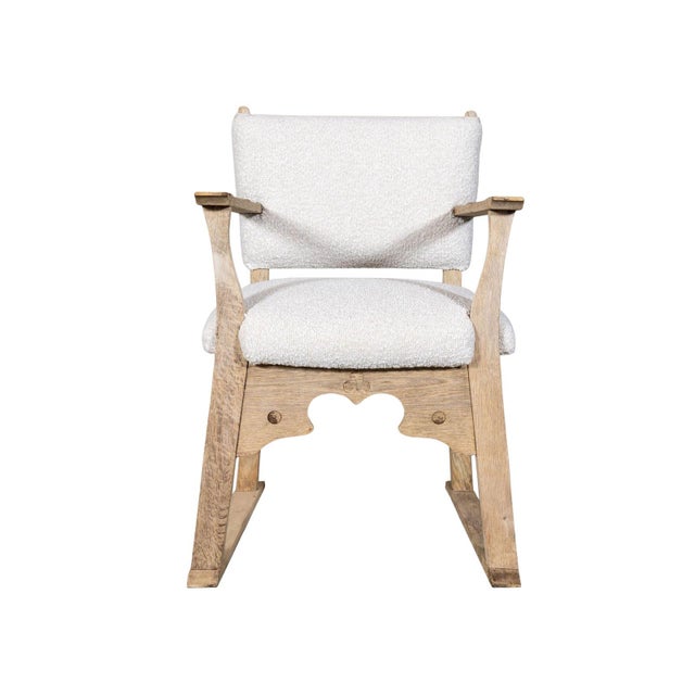 Upholstered armchair with sled base. Carved sculptural apron.