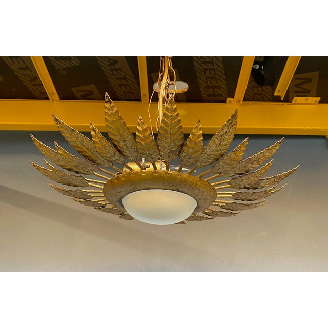 This brilliant gilt metal flush mount ceiling fixture from the 1960s is truly a stunning piece of Spanish craftsmanship....