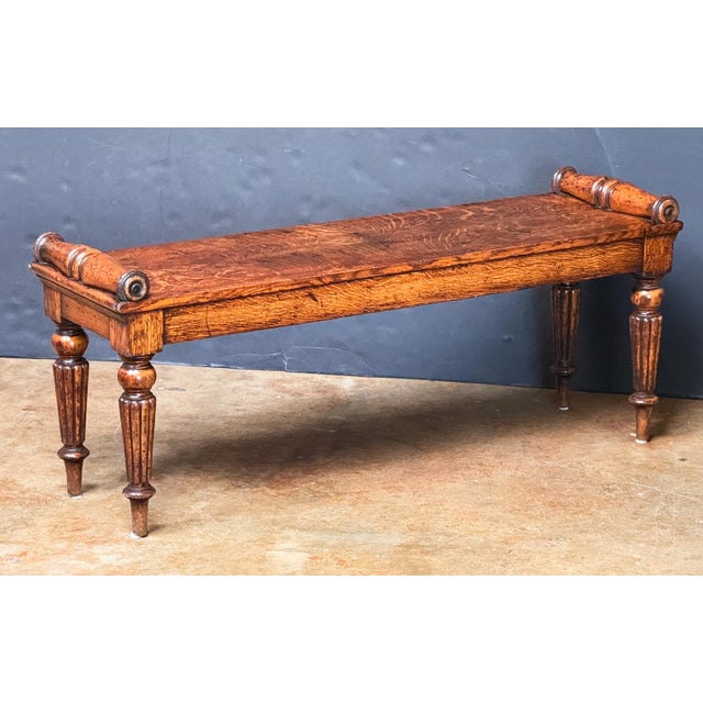 A fine English hall bench or window seat or stool of oak from the William IV period, featuring turned bolsters at opposing...