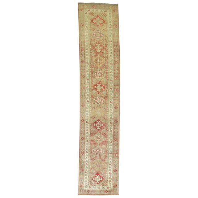 Vintage Turkish runner highlighted by a predominant soft pink color. Measures: 2'8" x 12'7".