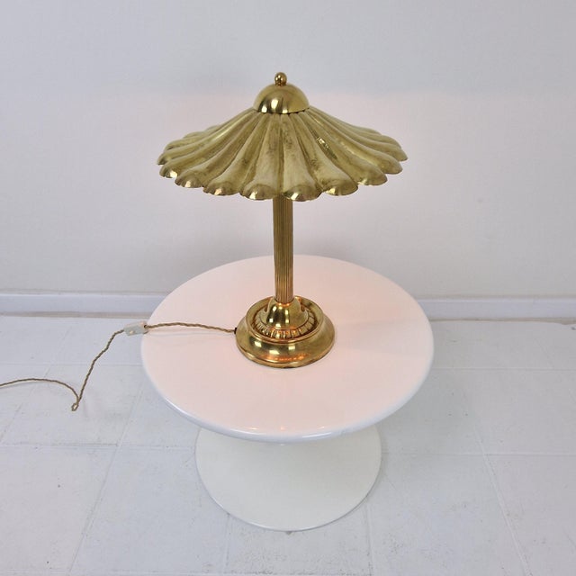 Exceptional and rare Italian table lamp from the 1970s, executed in richly polished solid brass with an extraordinary...