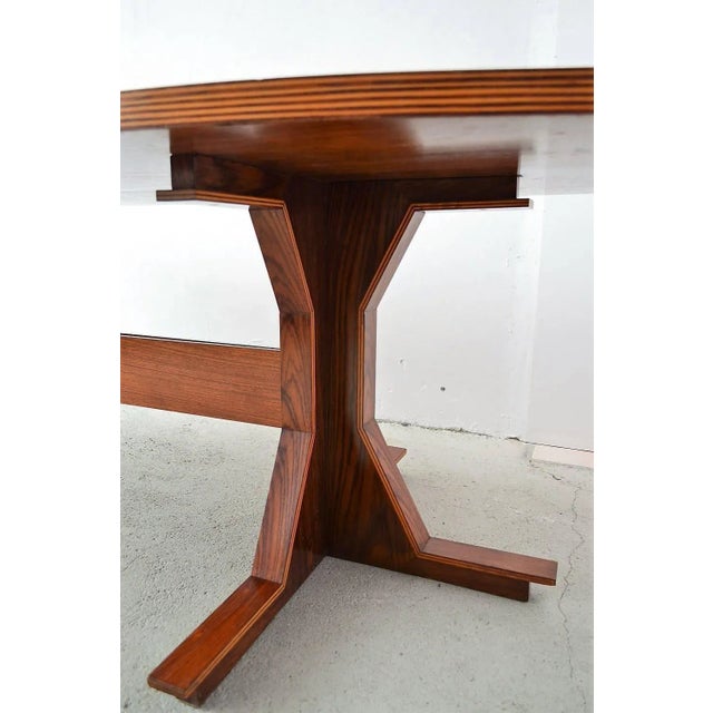 Hugh wooden table with beautiful and particular details in the style of Gianfranco Frattini. Excellent craftsmanship in...