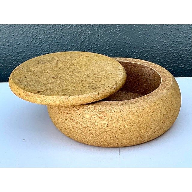 This chic vintage lidded box is a masterclass in organic minimalism, celebrating the raw, tactile beauty of natural cork....