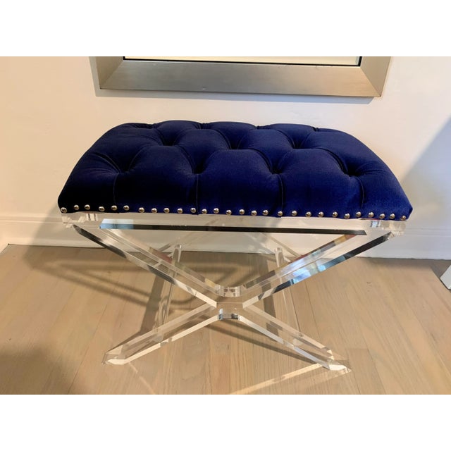This lovely tufted bench with royal blue velvet sits atop a clear lucite X style base. Great for extra seating! We have...