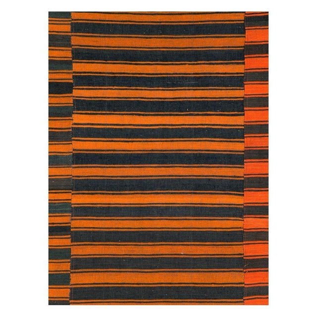 A vintage Turkish flat-weave Kilim room size accent rug handmade during the mid-20th century with a striped design in...