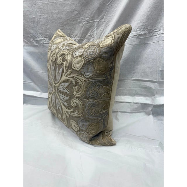 Add a dash of refined luxury to any room with this beautifully embroidered pillow, featuring a stunning silver and taupe...