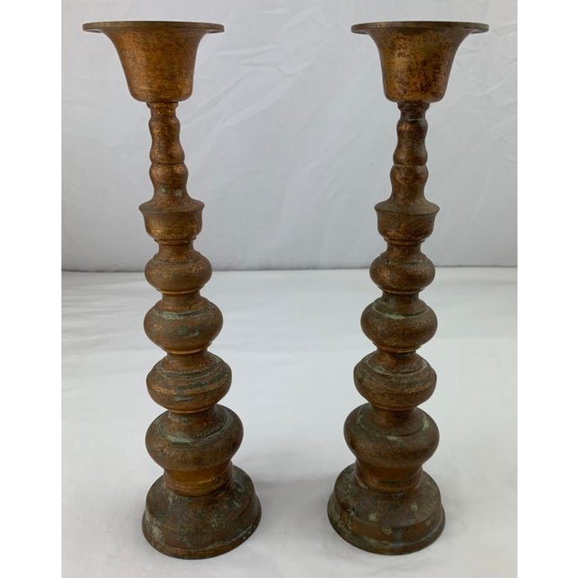 A pair of antique French Pascal Church style cast brass altar candlesticks. These candle holders have a nice mottled...