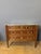 A 19th-century Louis XVI style walnut commode. It features three drawers separated by dividers. The four uprights are...
