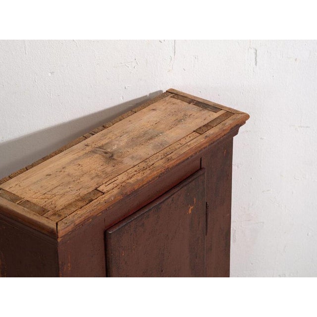 Antique painted cabinet in pine wood, central european rural furniture with burgundy paint originating from central europe...