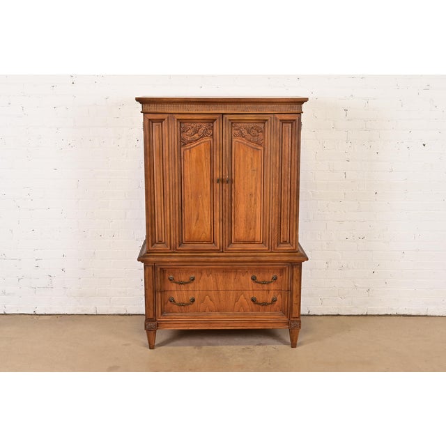 A gorgeous mid-century French Regency Louis XVI style gentleman's chest or highboy dresser In the manner of Henredon USA,...