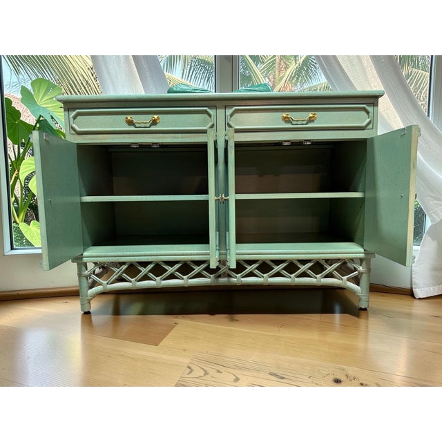 Bring classic Palm Beach Regency sophistication into your home with this stunning vintage rattan server by the renowned...