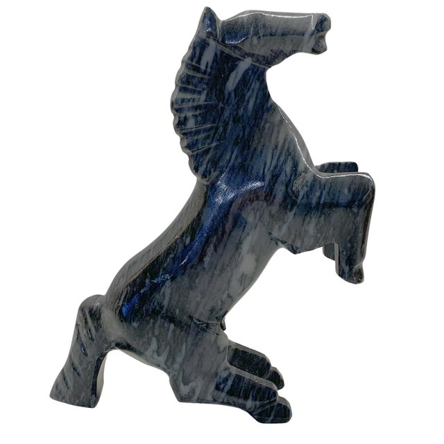 Vintage carved stone sculpture depicting a rearing horse with a stylized, geometric form. Crafted from polished black...