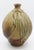 Swirlled body pottery vase by Ben Owen III, 1994. Richly striated drip glaze with incised lines setting off the swirlled,...