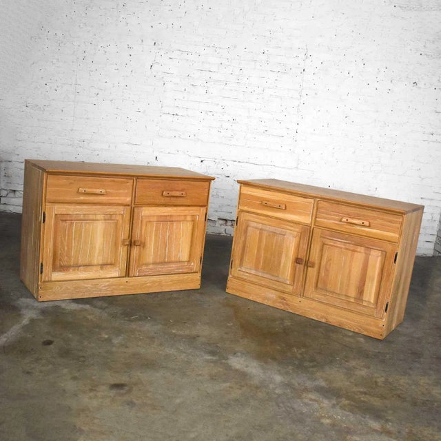 Fabulous pair of small credenzas or buffet cabinets by A. Brandt Company comprised of solid ranch oak with a natural oak...