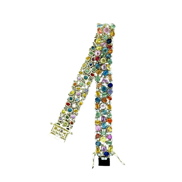 A contemporary creation from the 21st century, this tennis bracelet features a vibrant array of mixed-cut sapphires,...