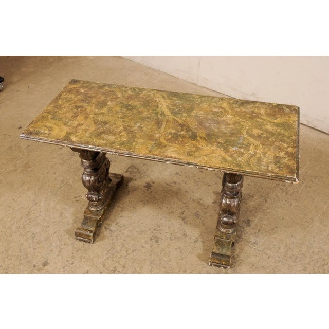 An Italian carved and painted wood coffee table from the turn of the 19th and 20th century. This antique table from Italy...