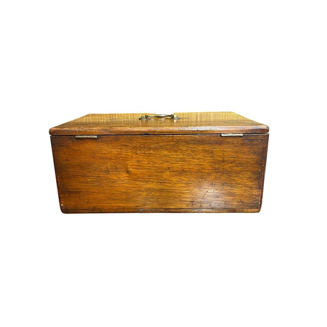 A large wooden box with a brass handle , made rather simply, great patina.. Used for storing silver or important papers....