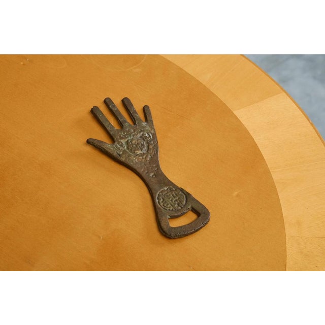 Hand Shaped Bottle Opener in Patinated Sand Cast Iron, Asia - most probably Japan, 1960s. Cast in the shape of an open...