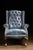 This vintage armchair features tufted leather and wooden construction. The chair is sturdy and ready for decades more use.