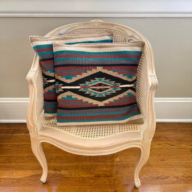 A pair of vintage Turkish kilim pillows with geometric woven color and soft wool texture. Bohemian global accents for a...