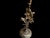 A handmade brass candlestick pair with a sculptural floral stem, petal-edged candle cups, and round embossed bases. The...
