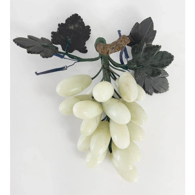 We are selling this decorative carved stone fruit. This probably Chinese soapstone is carved in the form of a bunch of...