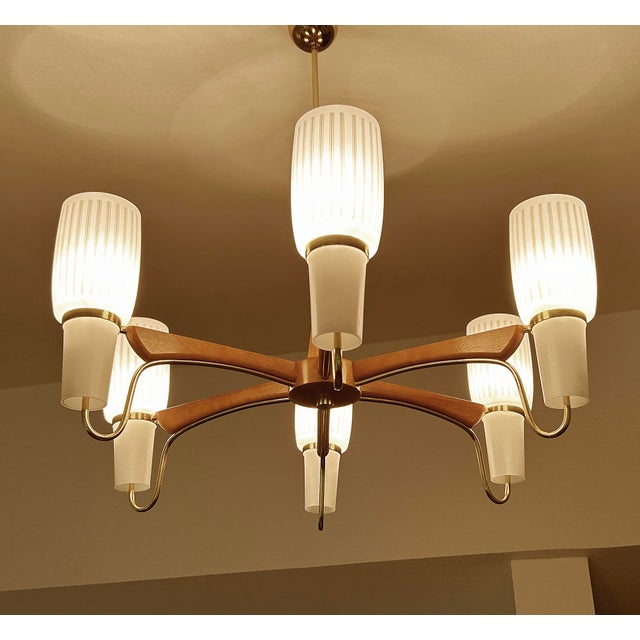 Large vintage danish modern style pendant light by Temde featuring 6 teak spokes with brass trim, center teak support,...