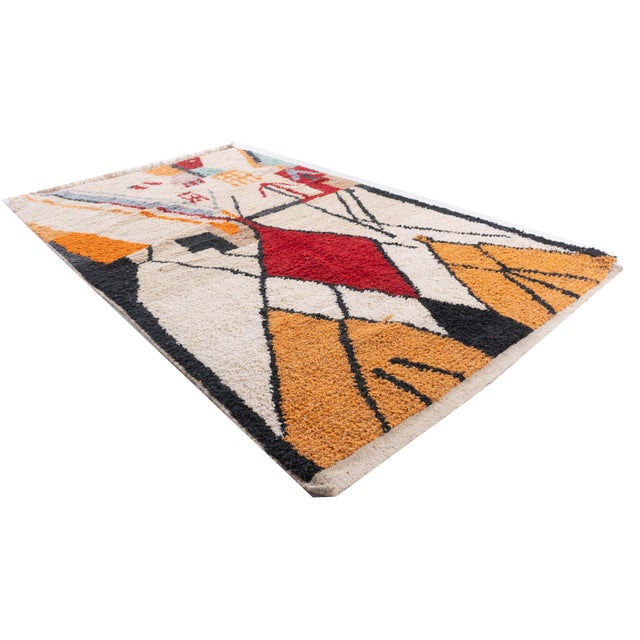 A modern Moroccan hand knotted rug. Colors: ivory/reds/blues/black.