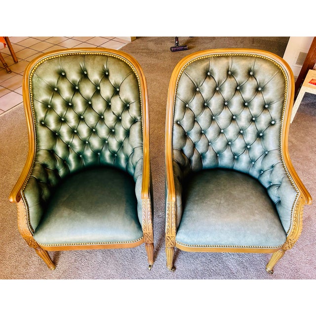 Beautiful pair of classic style tufted leather bergere chairs made by Hancock & Moore. Leather is high quality, full...