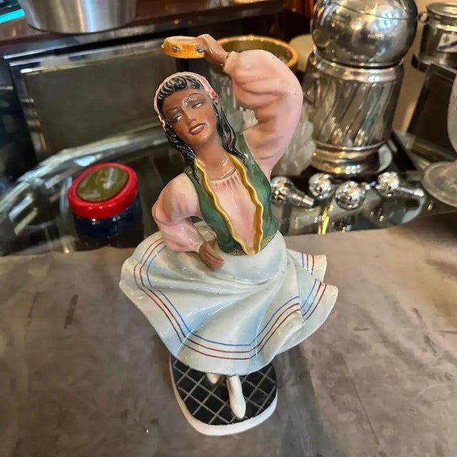 This striking hand-painted ceramic figure of a dancer is a masterpiece of Italian decorative art. It was created by the...