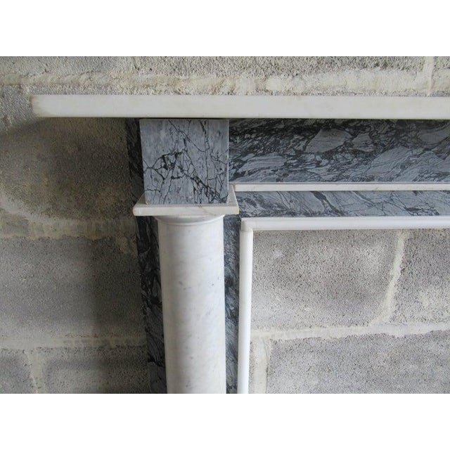A 19 century white carter’s and bardiglio column and marble fireplace. The tapered polished columns terminating on a block...