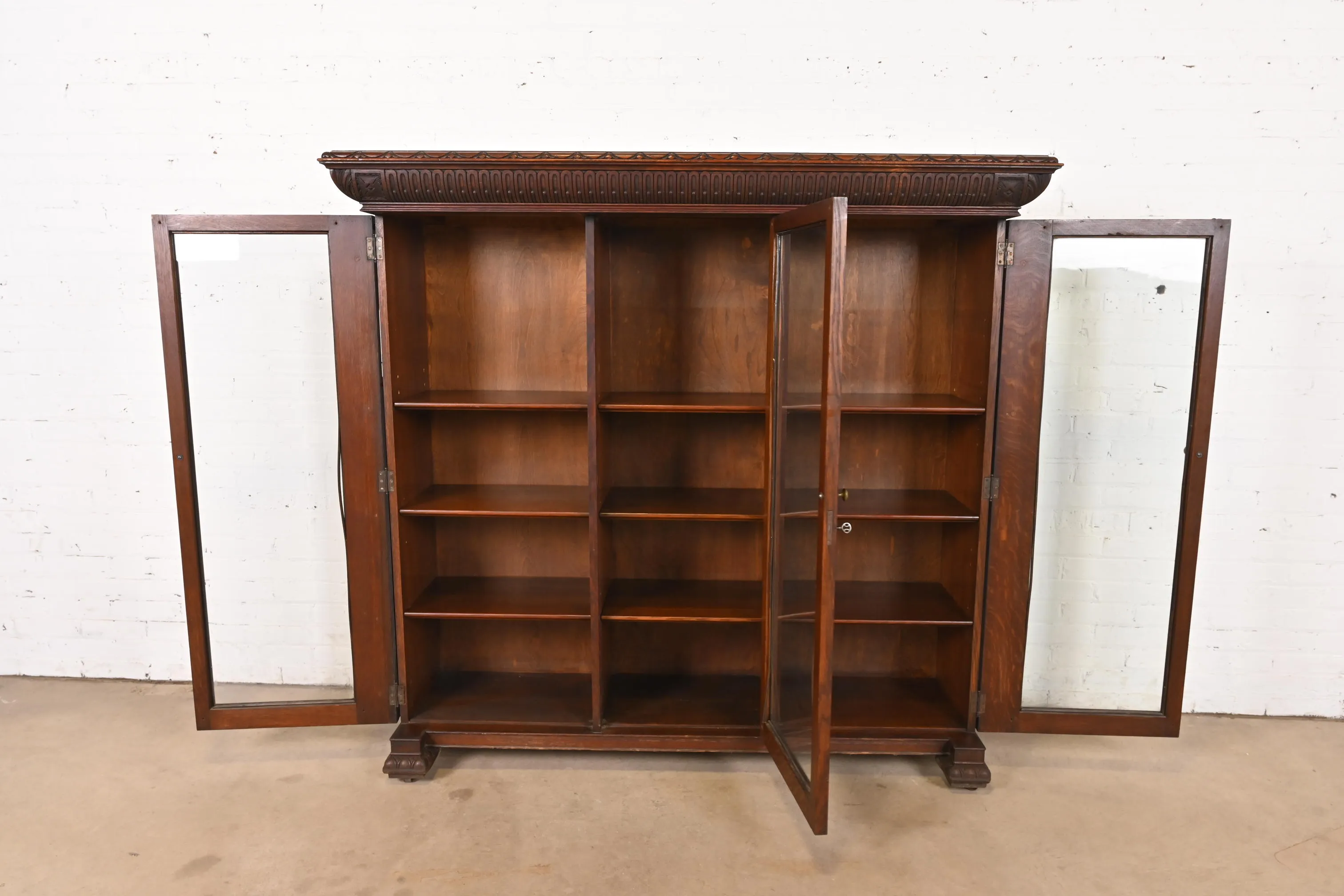 R. J. Horner Style American Empire Carved Oak Glass Front Triple