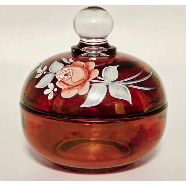 A rare and richly colored ruby glass lidded bowl by Westmoreland Glass, signed “C. Peltier 1978” and bearing the original...