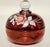 A rare and richly colored ruby glass lidded bowl by Westmoreland Glass, signed “C. Peltier 1978” and bearing the original...