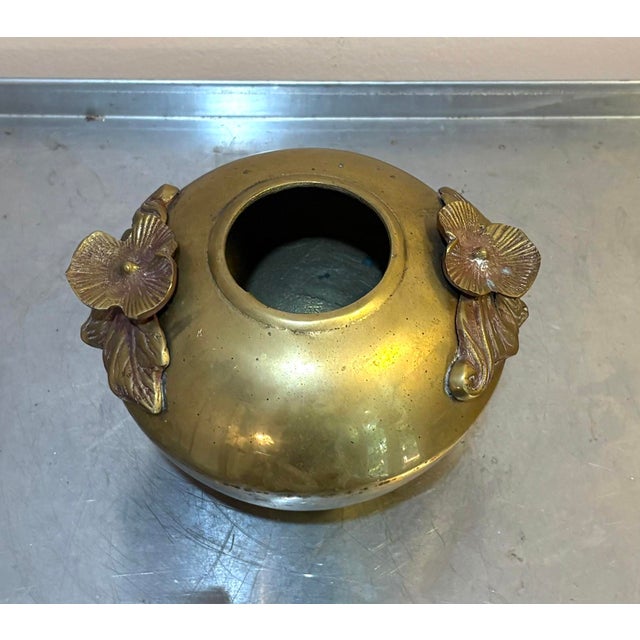 1960s-70s heavy brass tapered planter/vase w/ flower side detail. Some minor patina to metal in a few spots throughout, as...