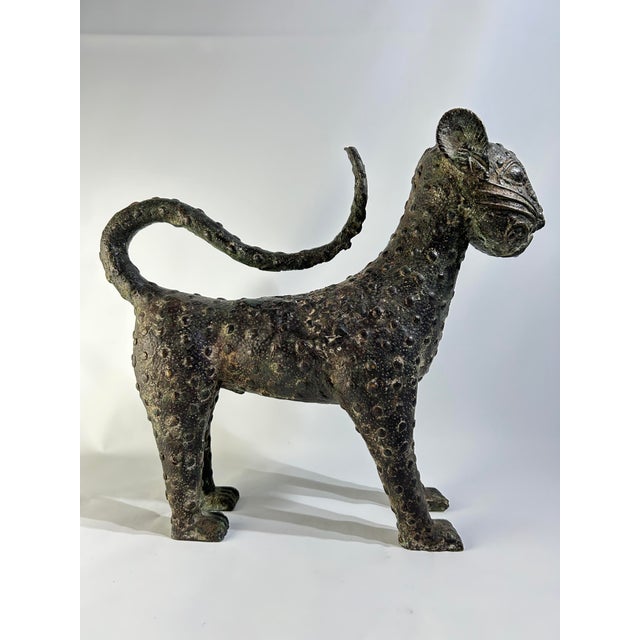 Mid 19th Century African Benin Bronze Leopard, Nigeria. Bronze leopard on a wood platform base. The sculpture created...