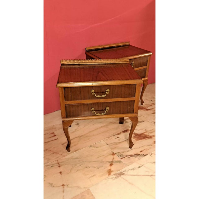 Set of two classic/vintage style bedside tables, characterized by their curves and two drawers with ornamental bronze...