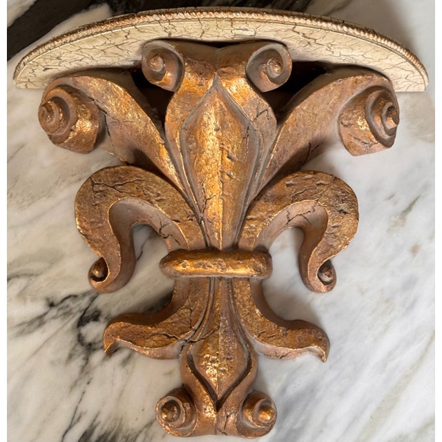 Here is a Florentine style gold gilt fleur de lis motif wall sconce in heavy wood composite resin. It is heavy for its...