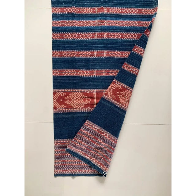 This Ikat textile originates from the Island of Timor, Indonesia. It is hand-woven using naturally dyed yarns via a method...