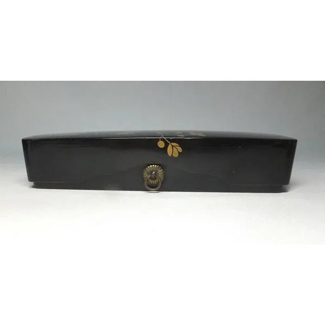 A Japanese lacquered letterbox from the Edo period. Painted with a flowering branch in gold maki-e and interior in labor-...
