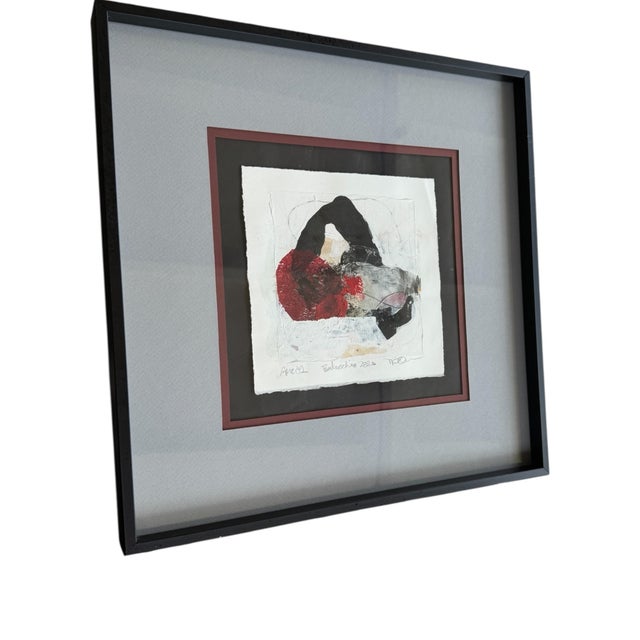 Abstract multimedia art with red, gray and black motif. Professionally framed and double matted. Overall 14.5” x 14.5” Art...