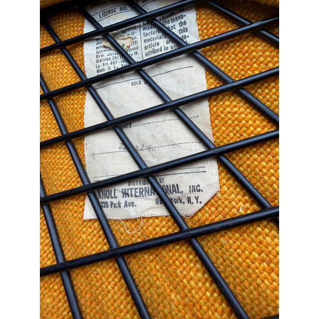 A striking pair of vintage Harry Bertoia Diamond Chairs for Knoll International, retaining their original mustard-gold...
