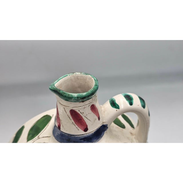 Vase, carafe, painted with flowers, majolica, 1940s-1950s, dimensions: height 23 cm, width 18.5 cm, depth 8.3 cm.